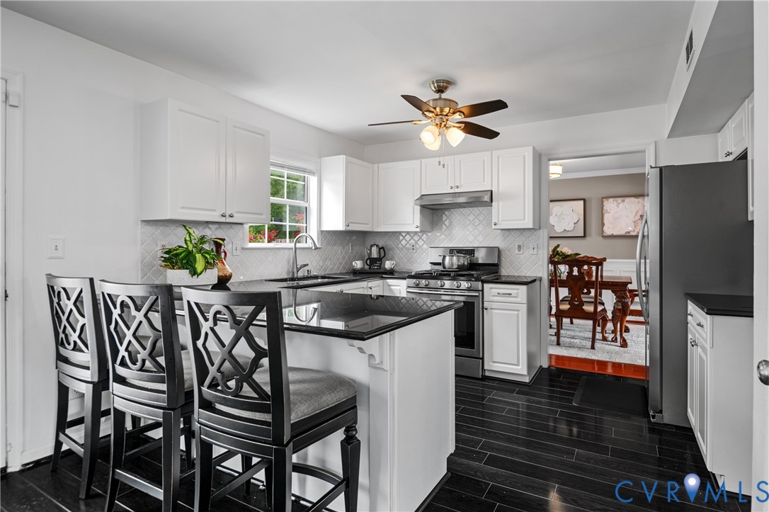 6356 Springcrest Lane Henrico, VA 23231 - Photo 3 of 43 a kitchen with stainless steel appliances granite countertop a stove top oven a refrigerator a sink and dishwasher