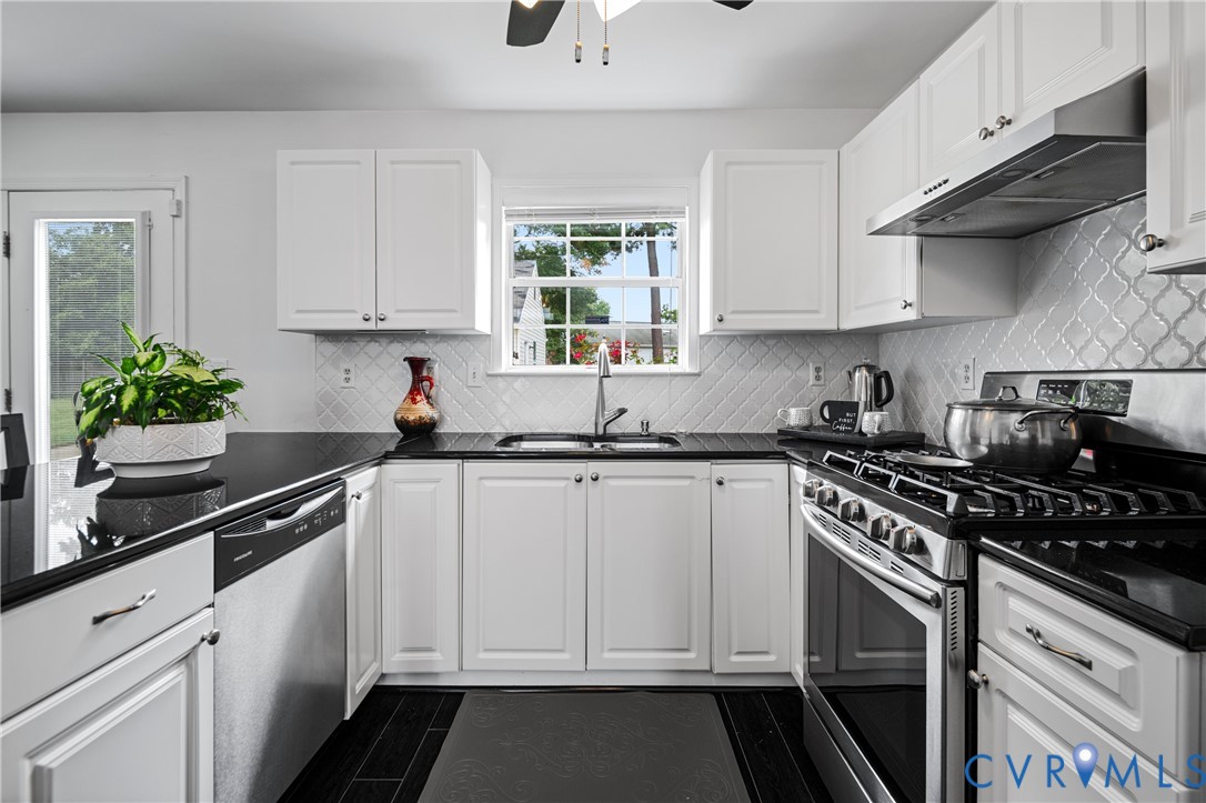 6356 Springcrest Lane Henrico, VA 23231 - Photo 4 of 43 a kitchen with granite countertop white cabinets and white appliances