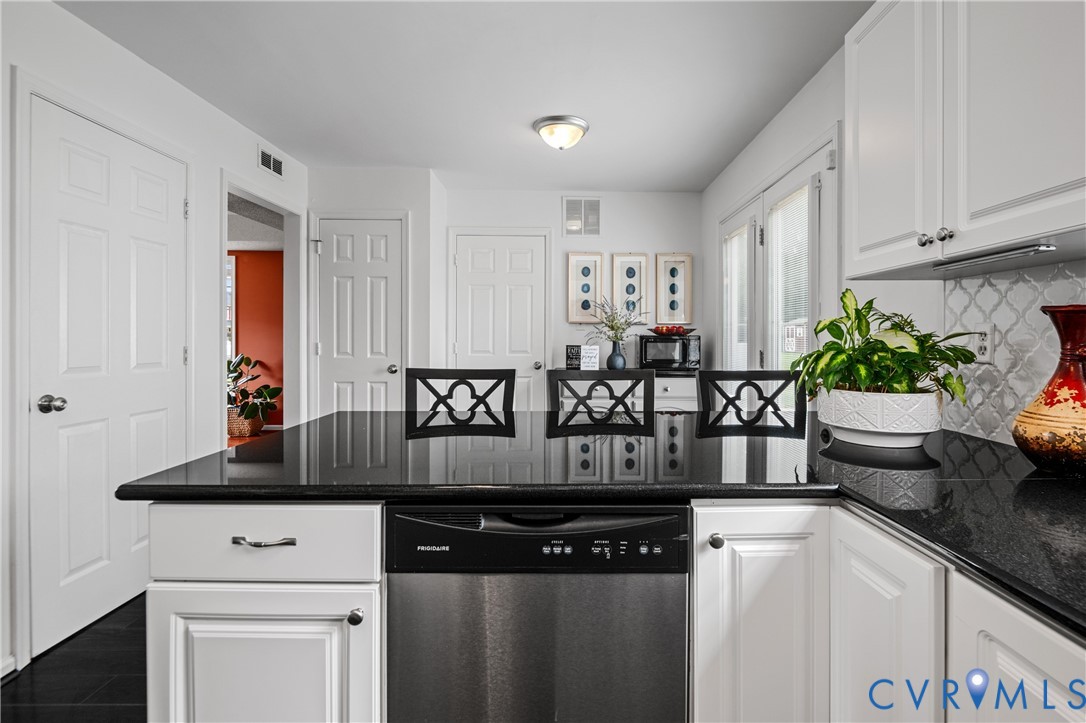 6356 Springcrest Lane Henrico, VA 23231 - Photo 5 of 43 a kitchen with granite countertop a sink a stove and white cabinets