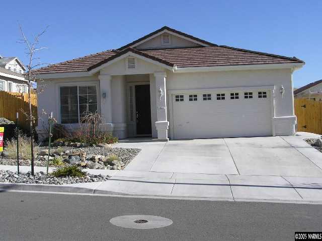 7234 Heatherwood Drive Reno, NV 89523 - Photo 1 of 9 a front view of a house with garage and parking