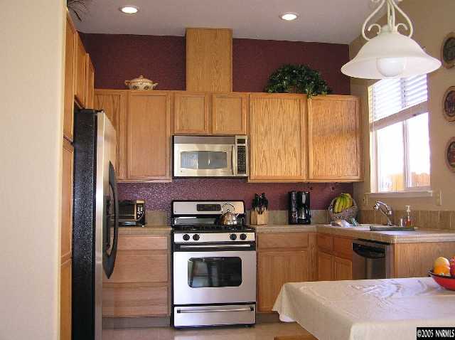 7234 Heatherwood Drive Reno, NV 89523 - Photo 2 of 9 a kitchen with a sink stove and refrigerator