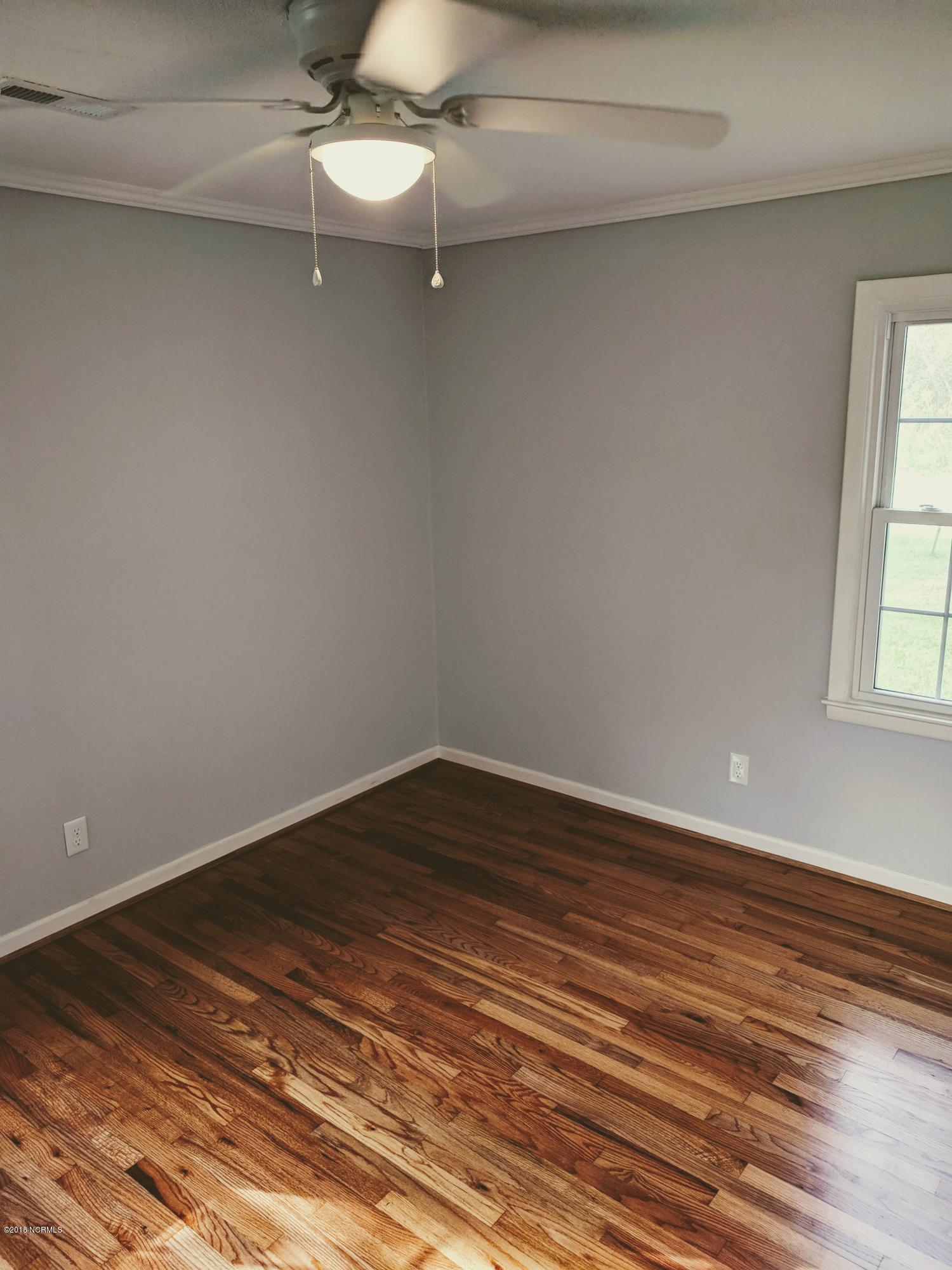 706 Tully Hill Road Kinston, NC 28504 - Photo 12 of 16 Spacious Rear bedroom. Don't you just love those refinished hardwood floors?