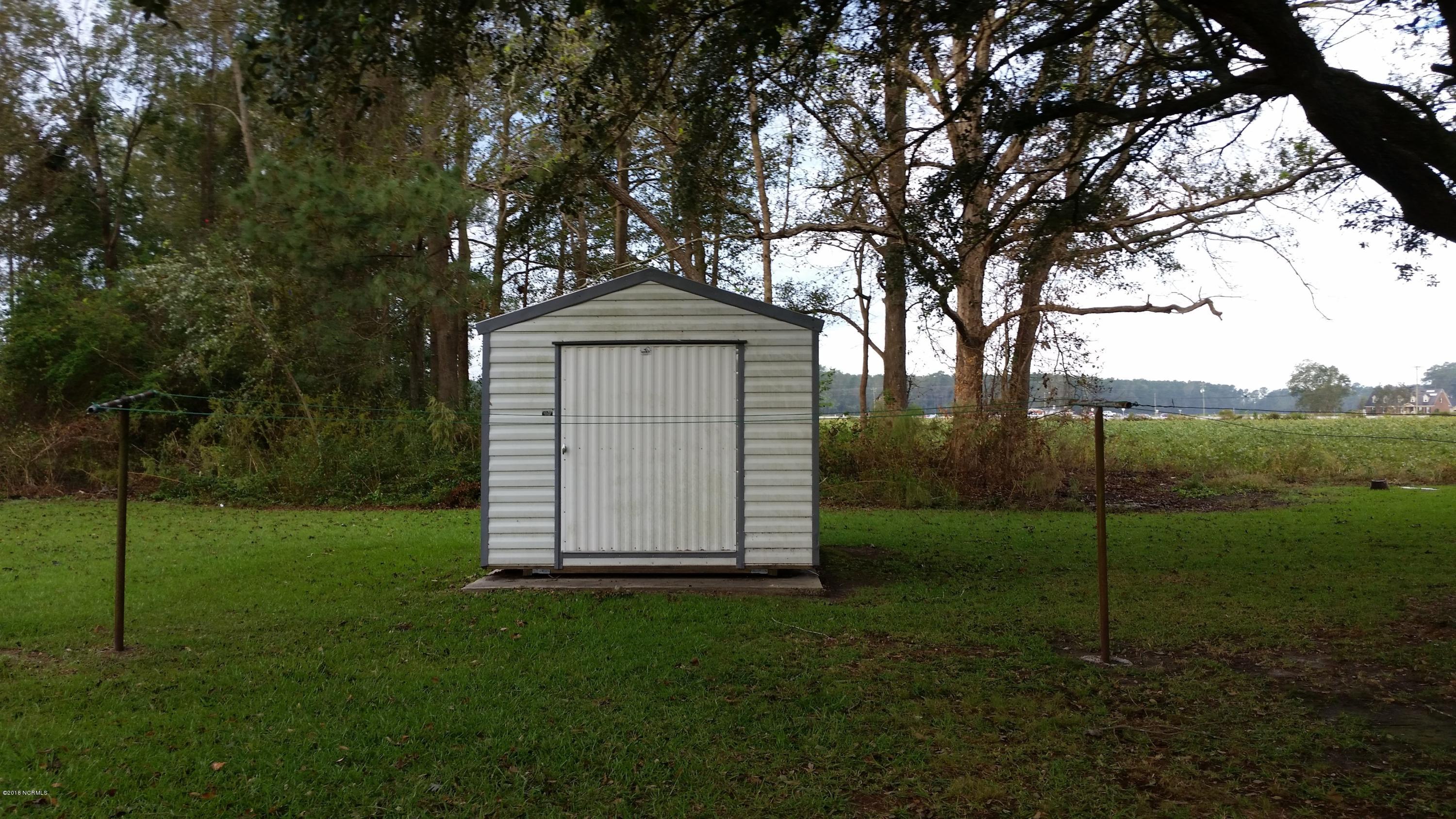 706 Tully Hill Road Kinston, NC 28504 - Photo 15 of 16 Shed is wired for power, but there is not power line running to it at this time. There is a second storage room built onto the house.