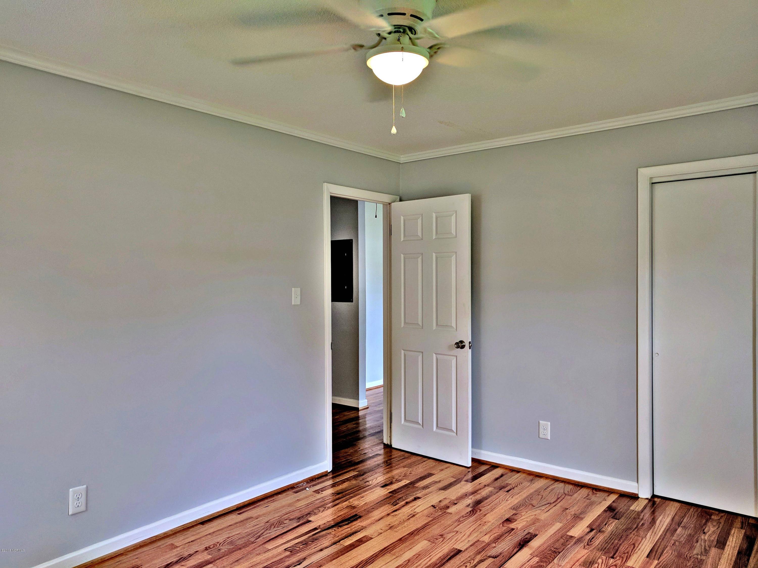 706 Tully Hill Road Kinston, NC 28504 - Photo 8 of 16 Front bedroom. Original hardwood floors have been refinished throughout the house.