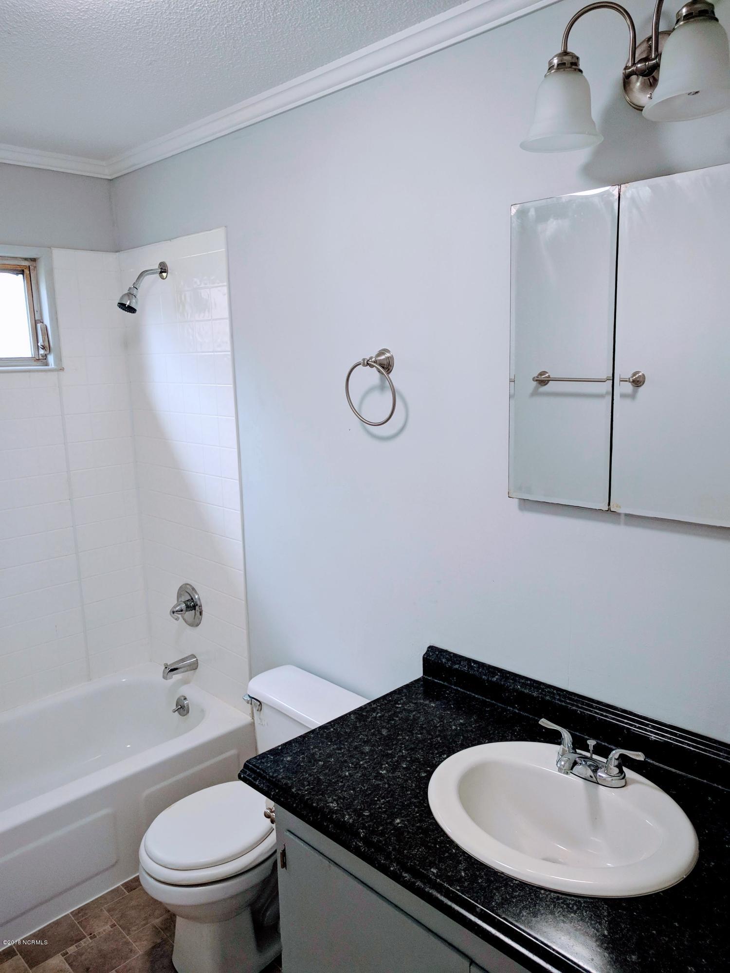 706 Tully Hill Road Kinston, NC 28504 - Photo 10 of 16 New tub/shower surround. New sink & counter top. Terrific new mirrored cabinet. New flooring.