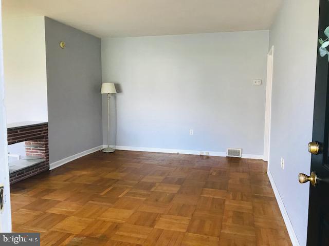 Spacious room with warm wood floors.