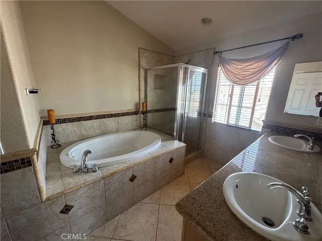 a bathroom with a tub a sink and a mirror