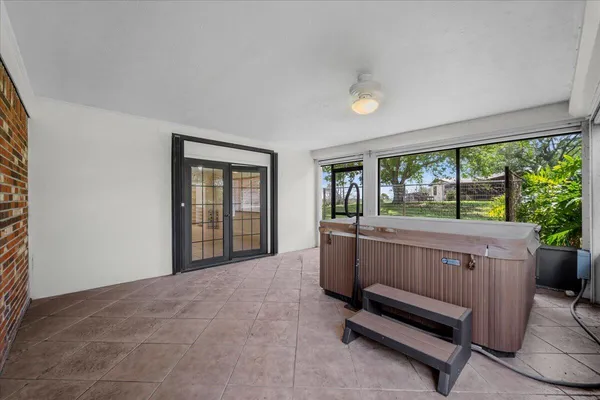 a view of a livingroom with a chair and wooden floor