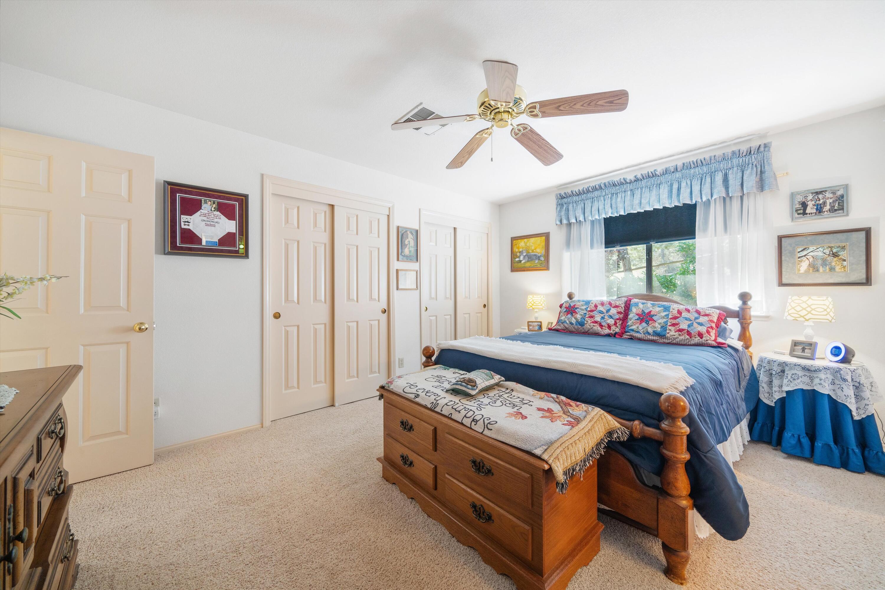 26460 Brian Place Tehachapi, CA 93561 - Photo 18 of 50 a bed room with a bed and a chandelier