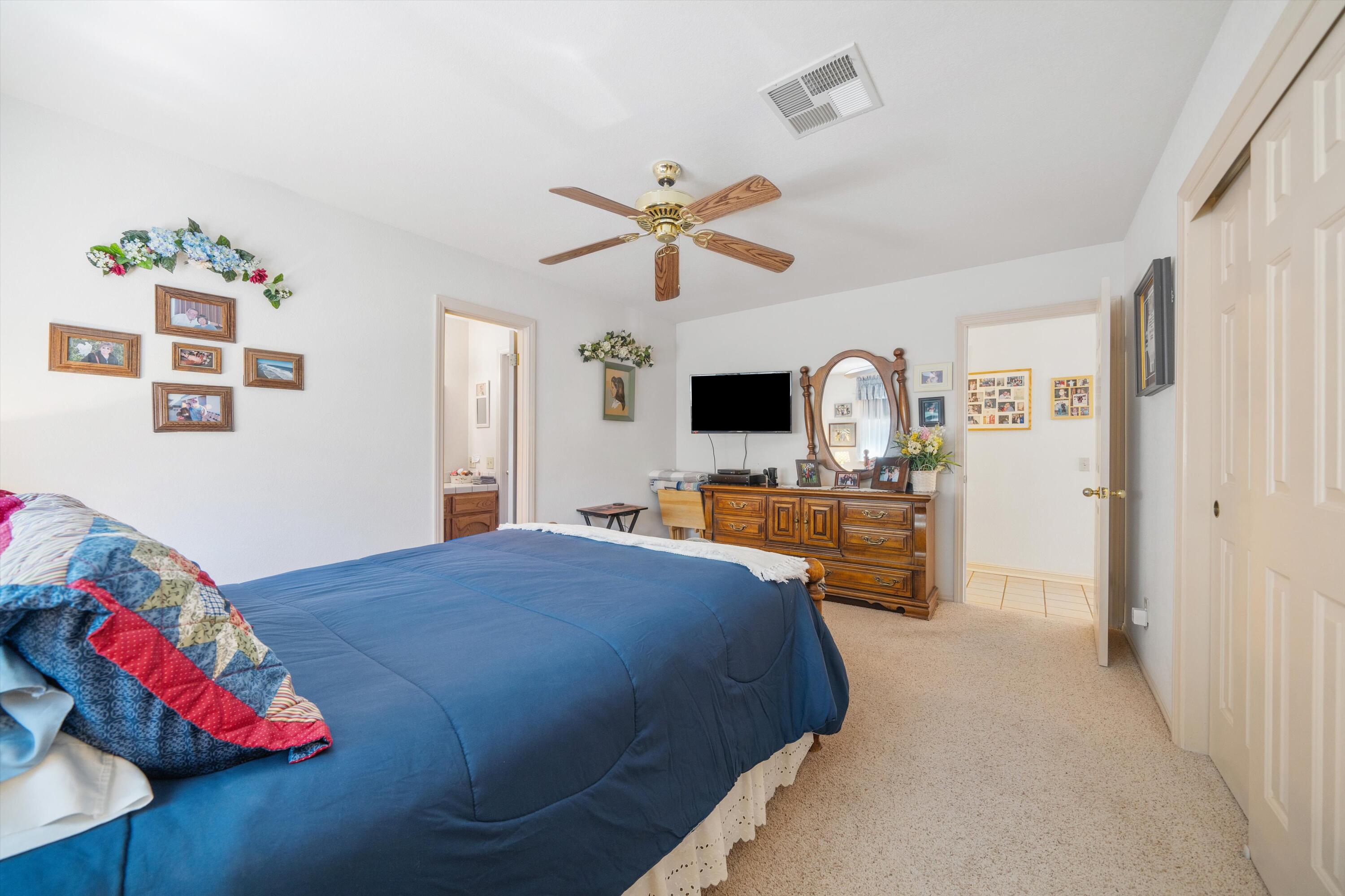 26460 Brian Place Tehachapi, CA 93561 - Photo 19 of 50 a bedroom with a bed and a flat screen tv