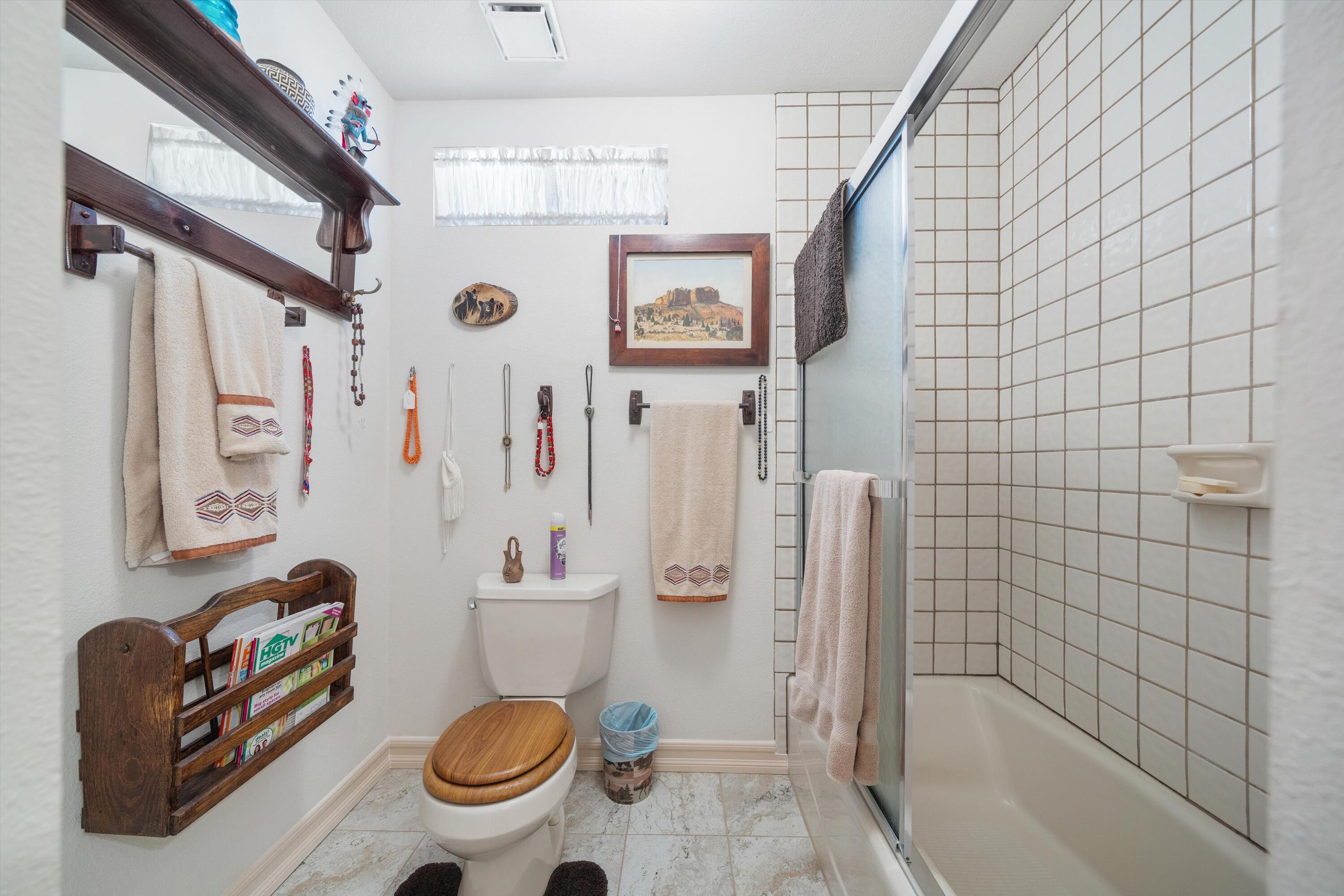 26460 Brian Place Tehachapi, CA 93561 - Photo 21 of 50 a bathroom with a sink a toilet and shower curtain