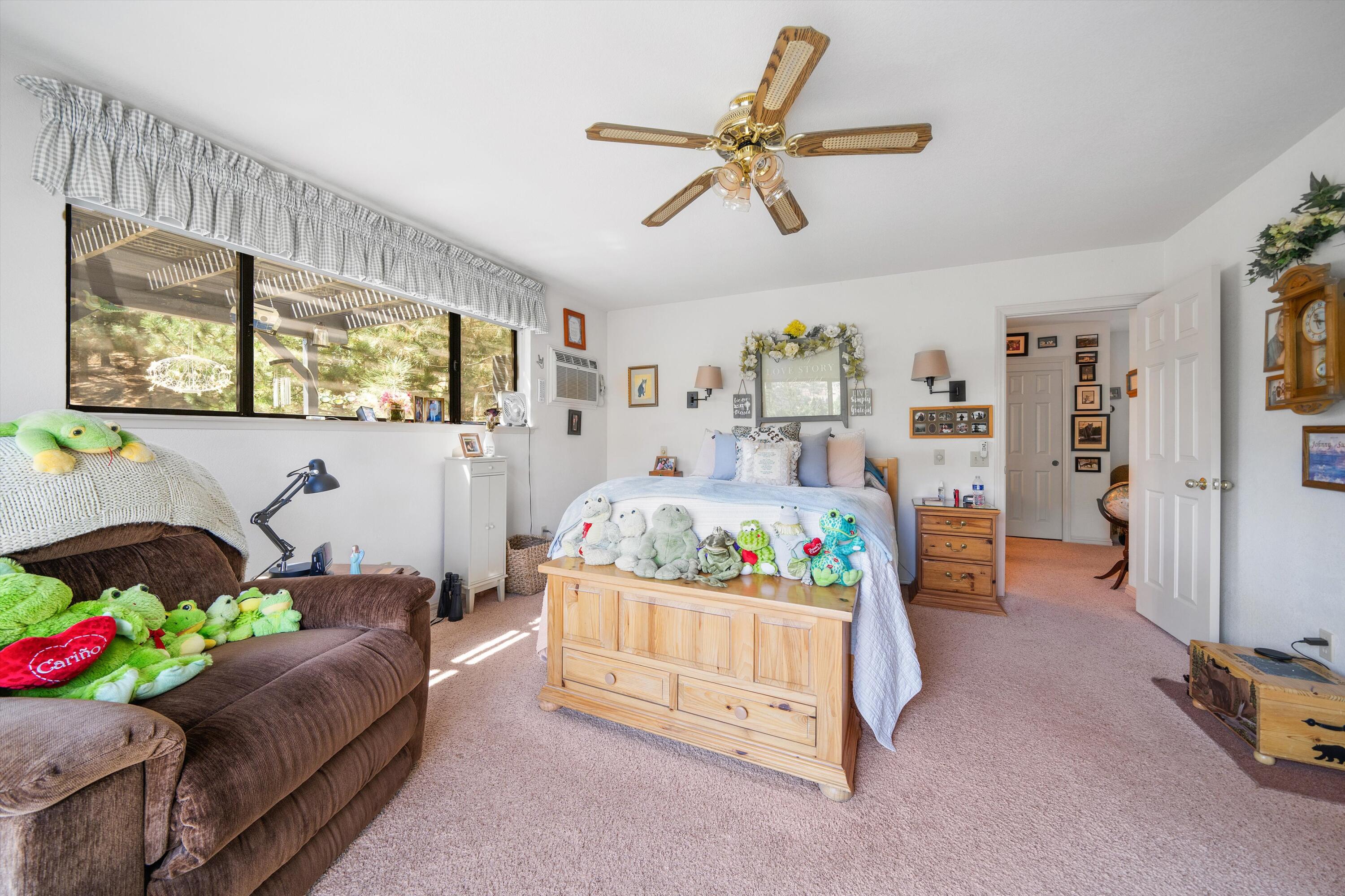 26460 Brian Place Tehachapi, CA 93561 - Photo 22 of 50 a bedroom with a bed and a chandelier