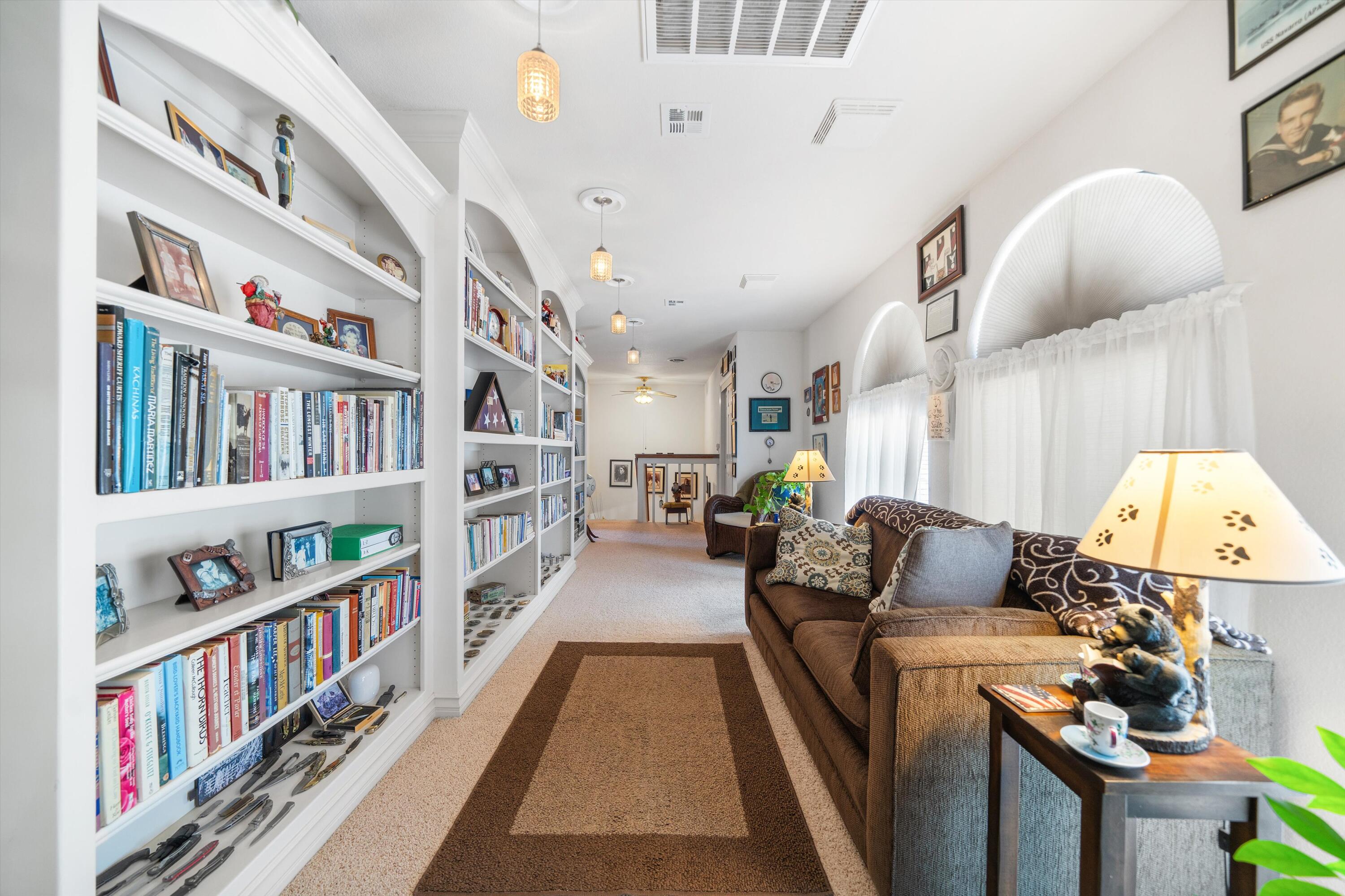 26460 Brian Place Tehachapi, CA 93561 - Photo 25 of 50 a living room with furniture and a book shelf