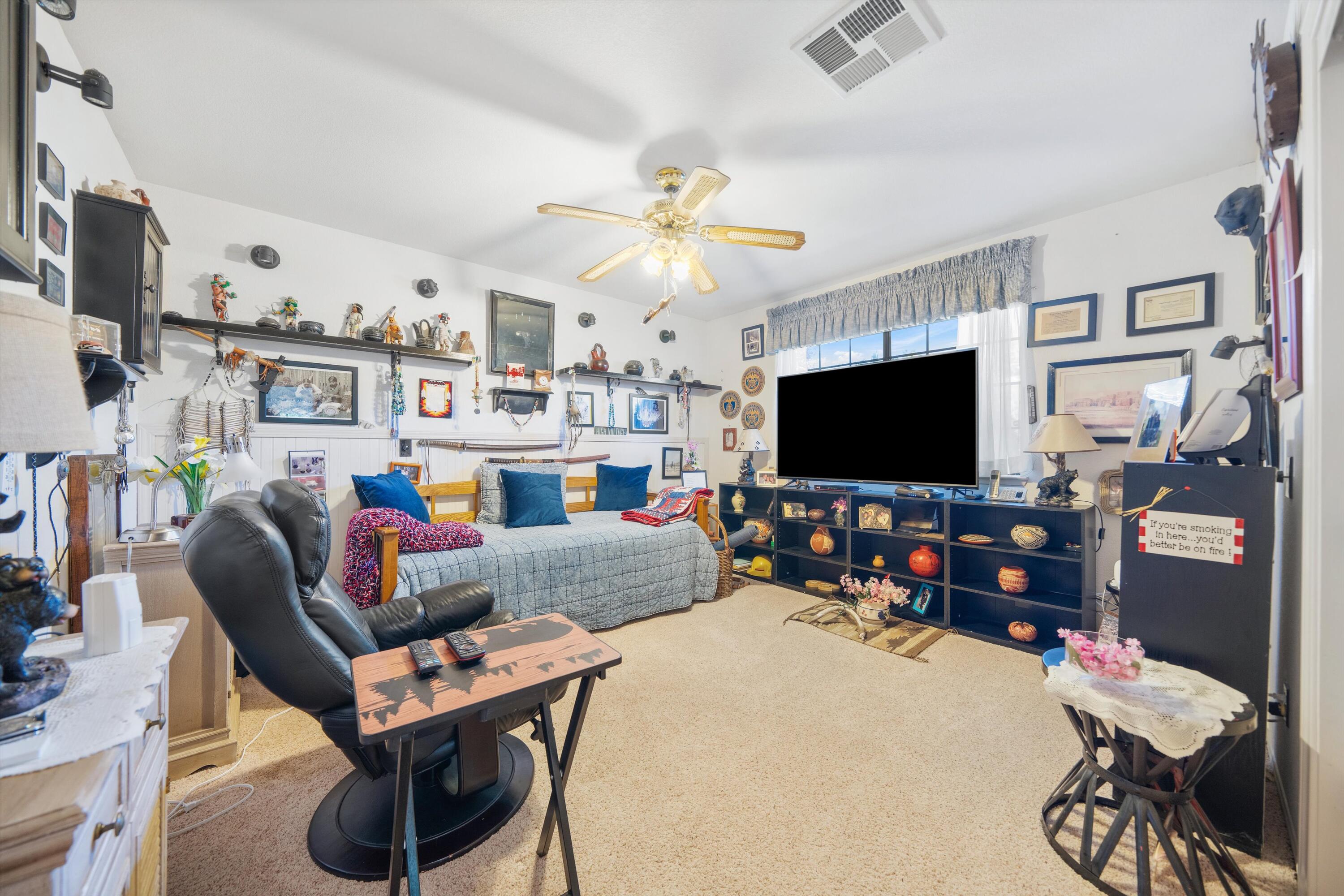 26460 Brian Place Tehachapi, CA 93561 - Photo 28 of 50 a living room with furniture and a flat screen tv