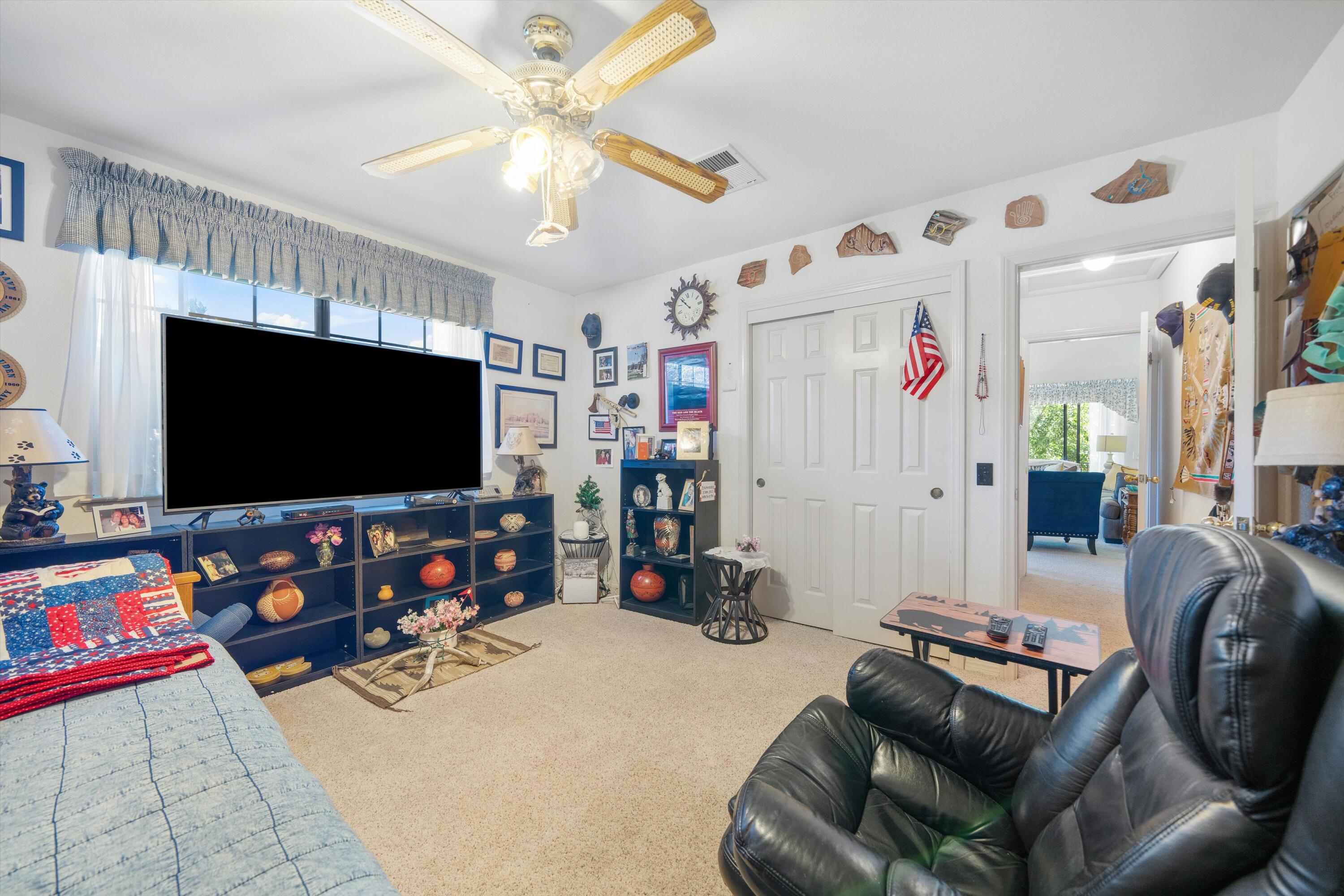 26460 Brian Place Tehachapi, CA 93561 - Photo 29 of 50 a living room with furniture and a flat screen tv