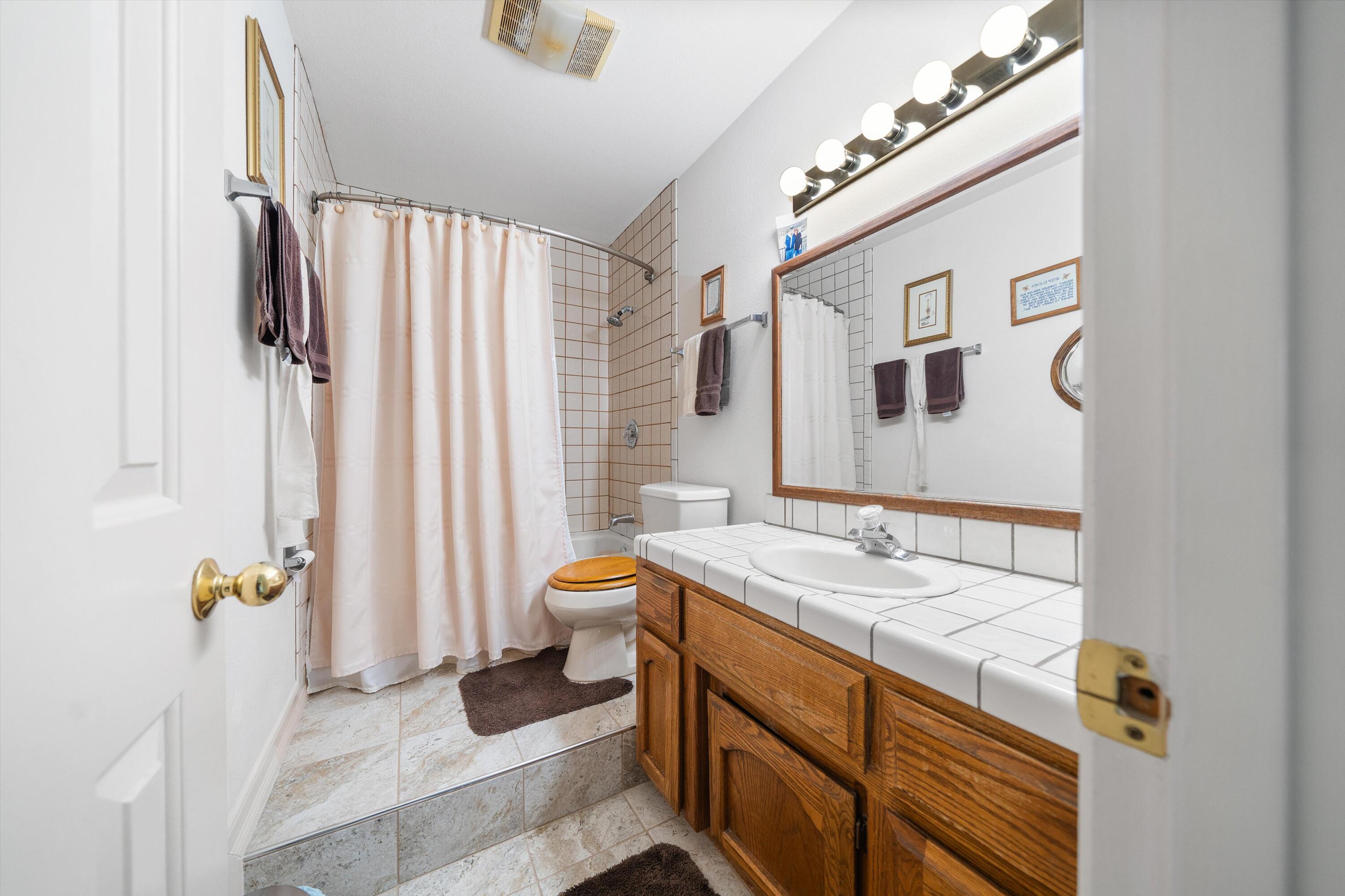 26460 Brian Place Tehachapi, CA 93561 - Photo 30 of 50 a bathroom with a sink toilet and shower