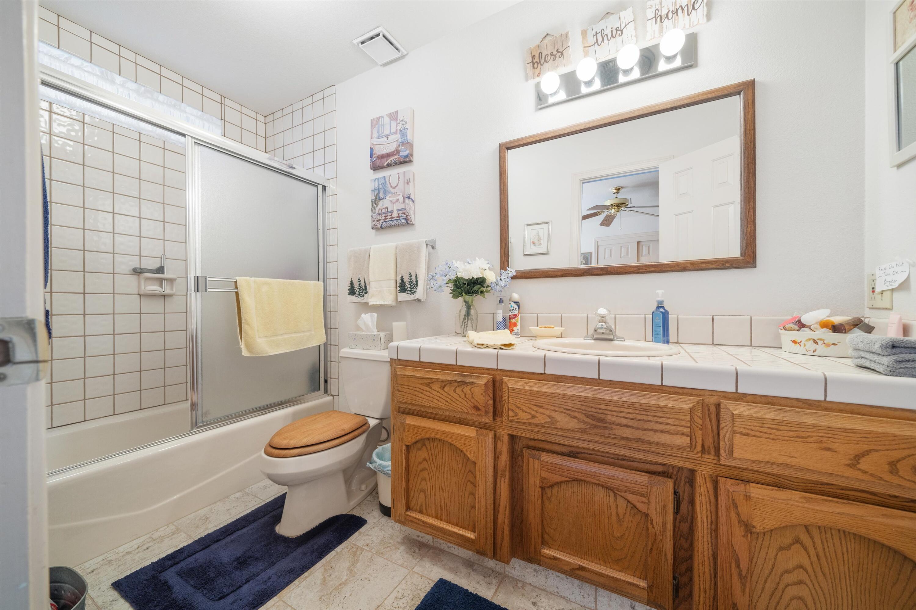26460 Brian Place Tehachapi, CA 93561 - Photo 31 of 50 a bathroom with a toilet sink and mirror