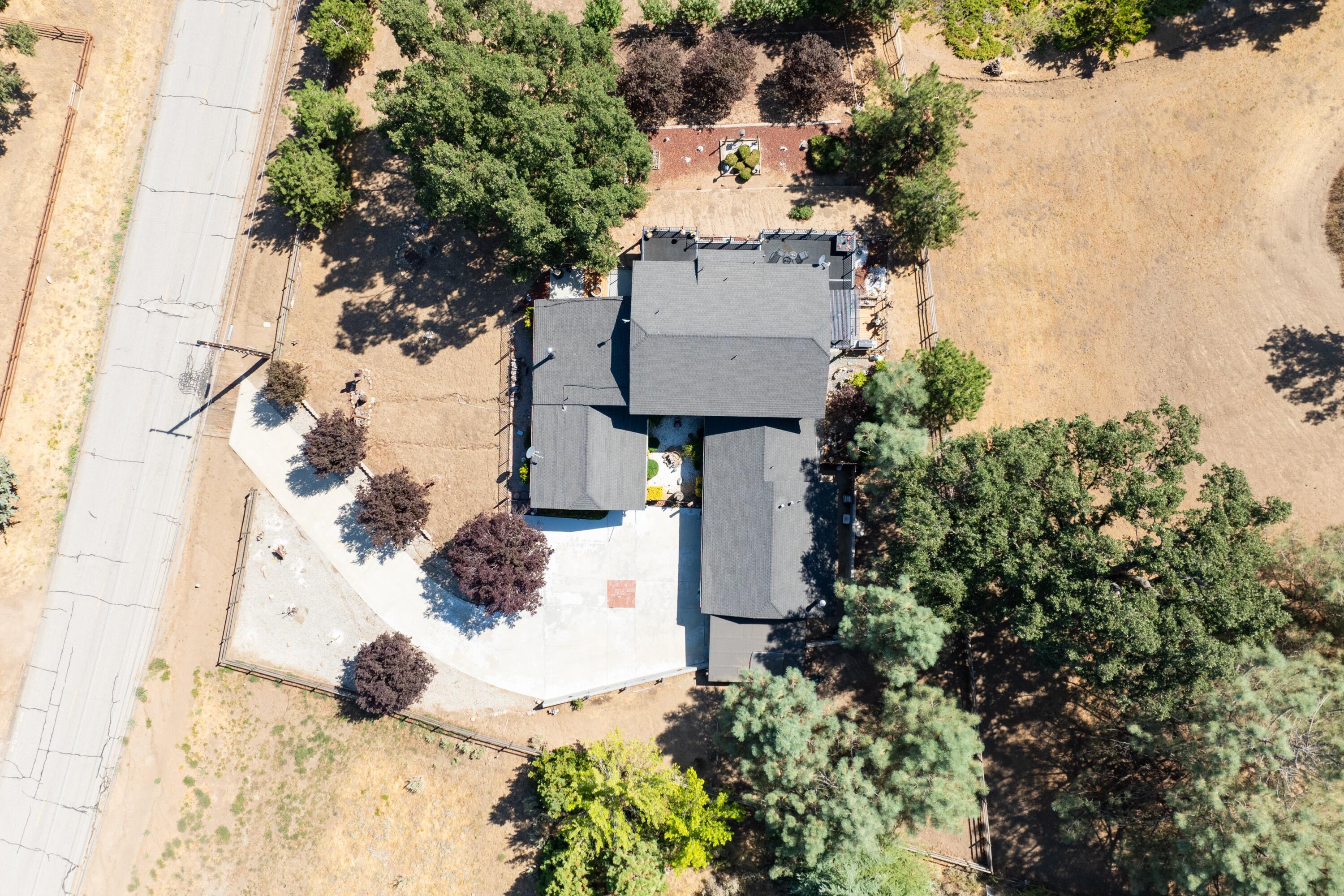26460 Brian Place Tehachapi, CA 93561 - Photo 41 of 50 a backyard of a house with lots of green space