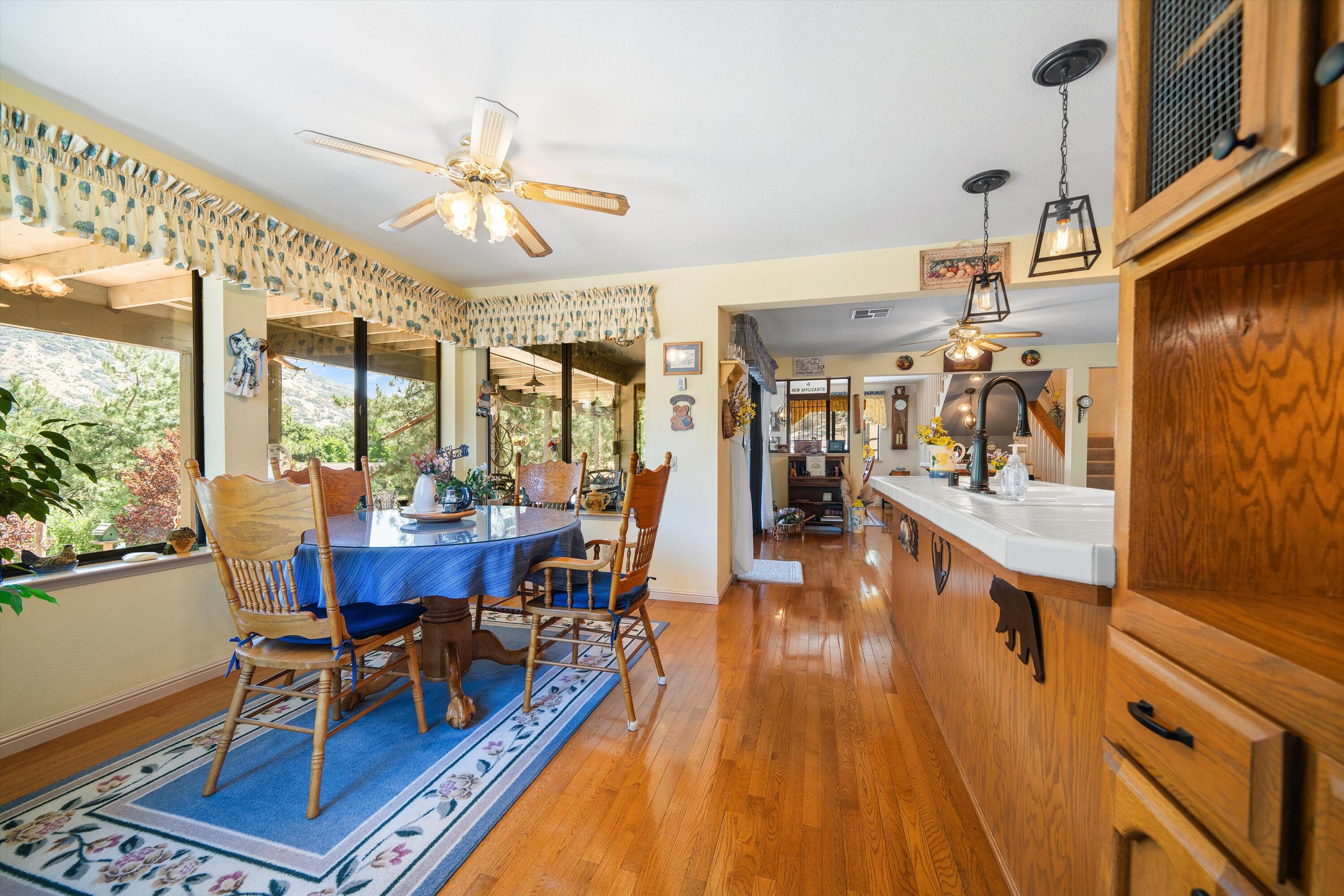 26460 Brian Place Tehachapi, CA 93561 - Photo 7 of 50 a view of a dining room with furniture a chandelier and wooden floor