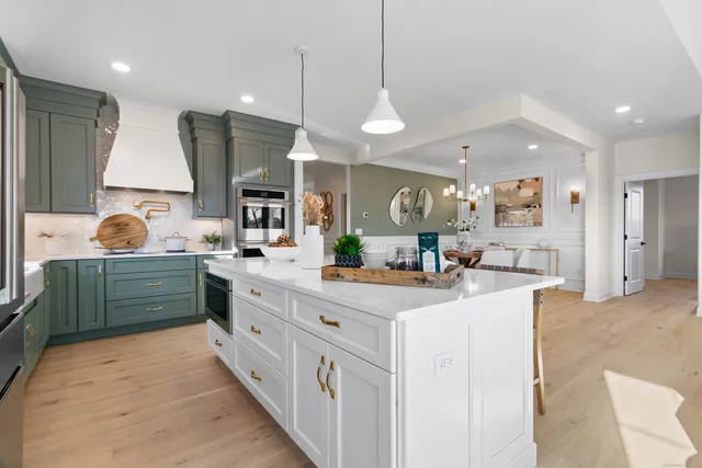a view of a dining room with furniture and chandelier