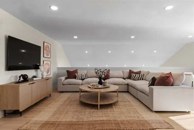 a bedroom with a bed and large windows