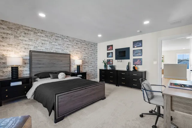 a bedroom with a bed and a desk