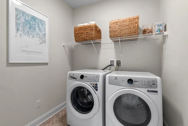 a kitchen with a table chairs refrigerator and microwave