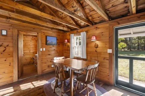 a view of a dining room with furniture large windows and wooden floor