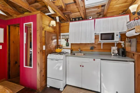 a kitchen with a sink stove and cabinets
