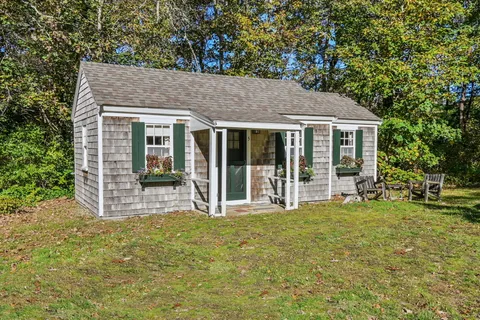 a view of a house with backyard porch and garden