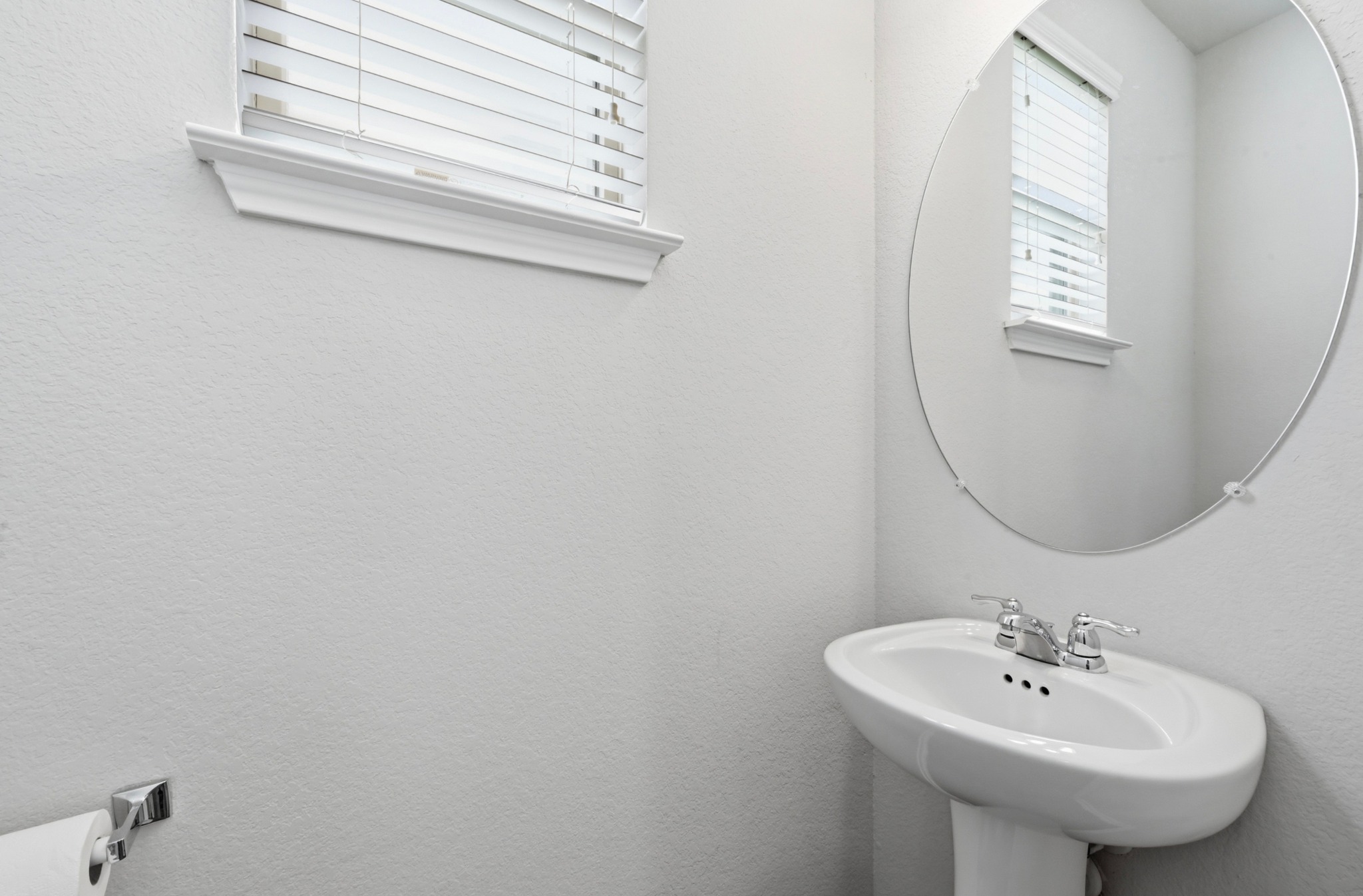 209 Noddy Road Buda, TX 78610 - Photo 14 of 30 Half Bath -Pedestal sink with chrome-finish faucet and oval mirror