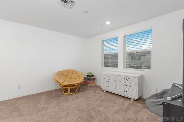 a spacious bathroom with a window and a potted plant