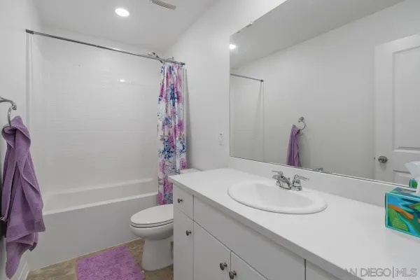 a bathroom with a sink toilet tub and shower