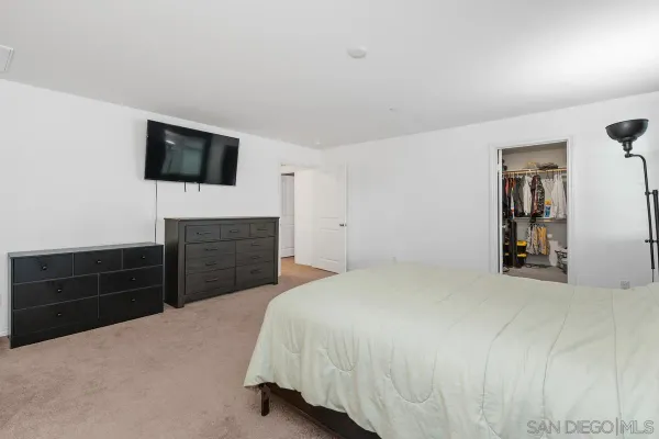 a bedroom with a bed and a television
