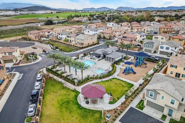 an aerial view of a house with outdoor space and a lake view