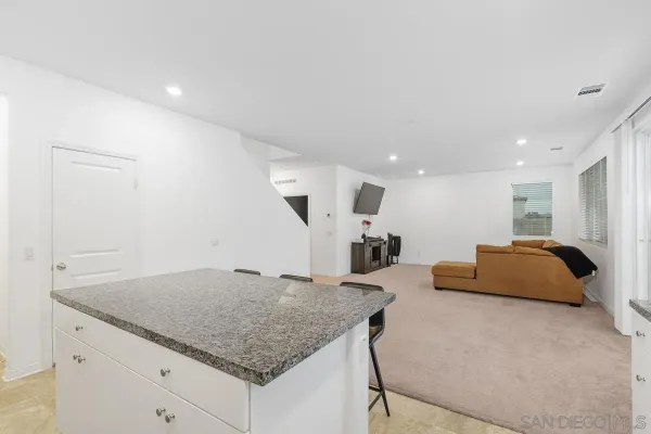 a spacious bedroom with a bed and a mirror
