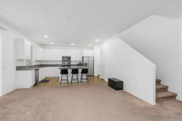 a kitchen with a table and chairs in it