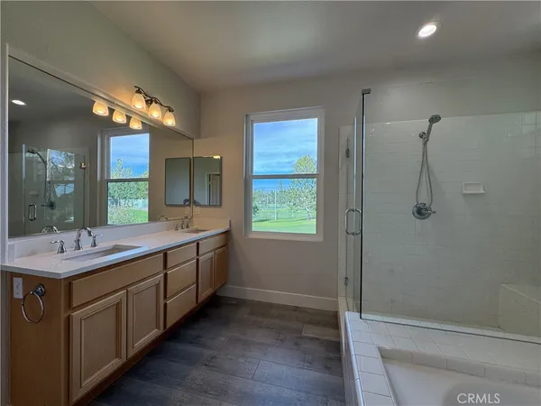 a bathroom with a double vanity sink toilet and shower