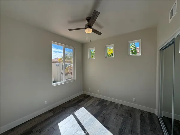 a view of wooden floor and windows in a room