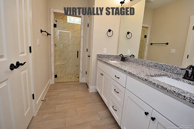 an empty room with wooden floor chandelier fan and windows