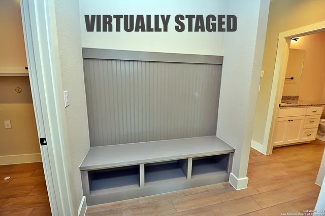 a view of cabinets and utility room with wooden floor