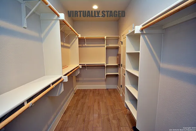 a spacious bathroom with a granite countertop sink a mirror and shower