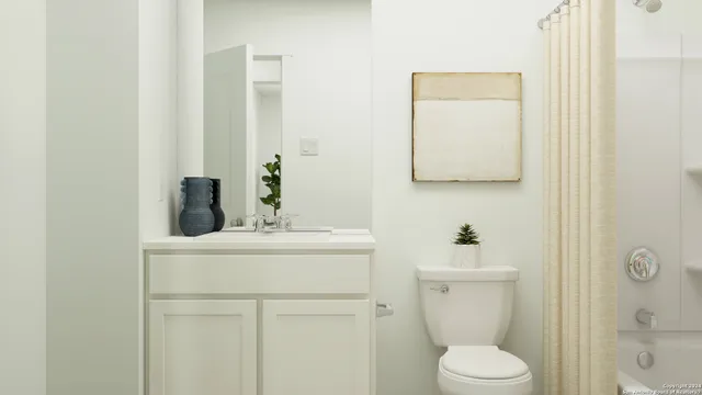 a bathroom with a toilet sink vanity and mirror