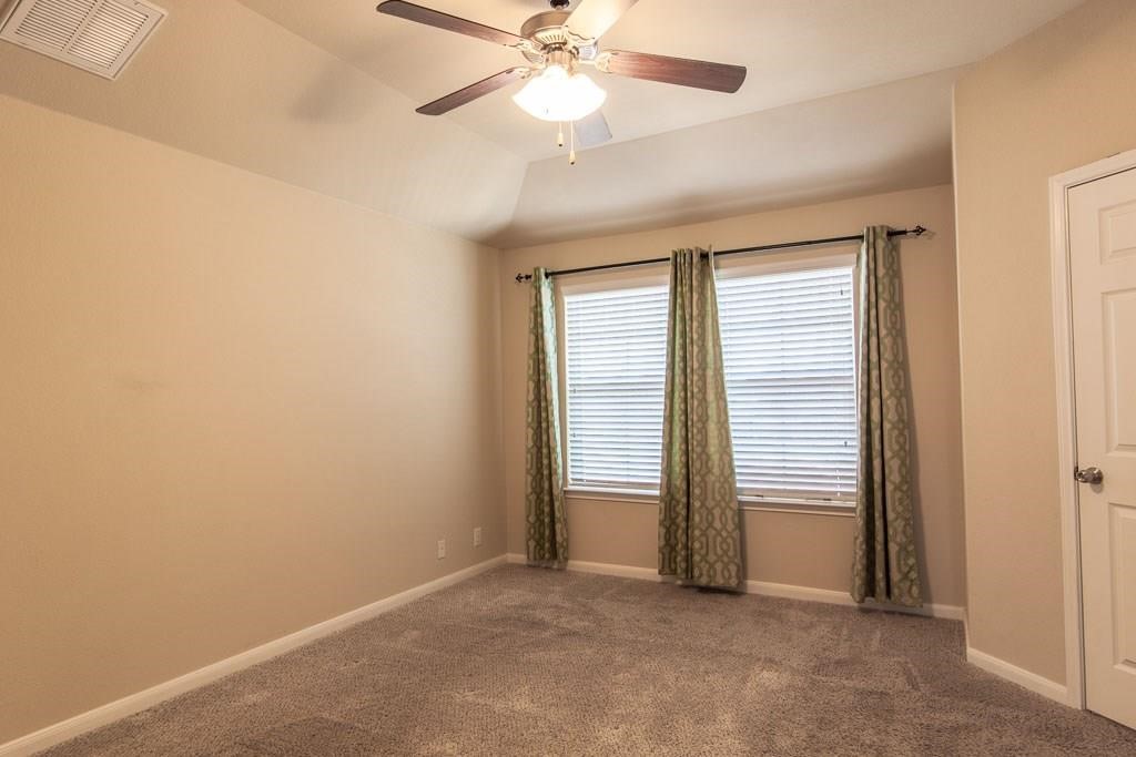636 Lookout Tree Lane Round Rock, TX 78664 - Photo 12 of 23 an empty room with windows and fan