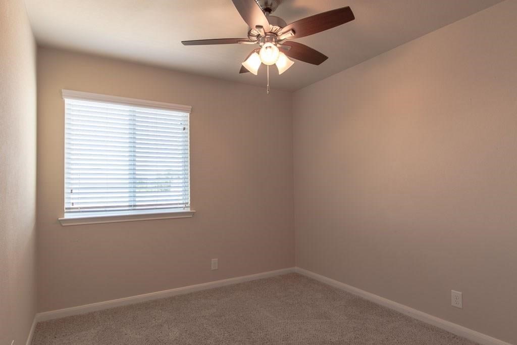 636 Lookout Tree Lane Round Rock, TX 78664 - Photo 14 of 23 an empty room with a window and a fan