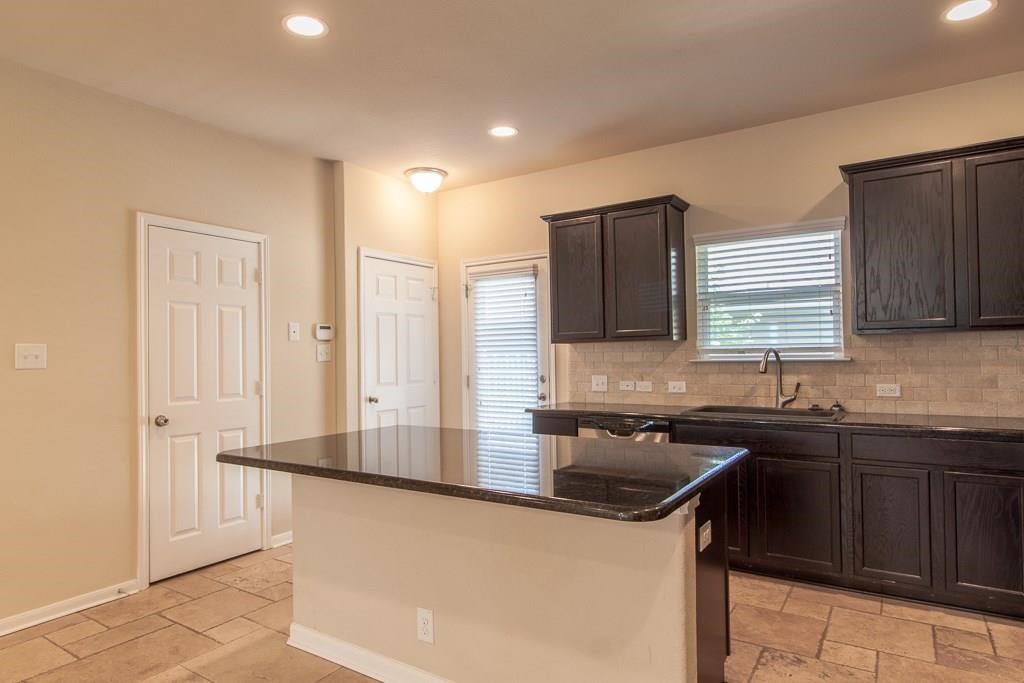 636 Lookout Tree Lane Round Rock, TX 78664 - Photo 7 of 23 a kitchen that has a sink and a stove in it