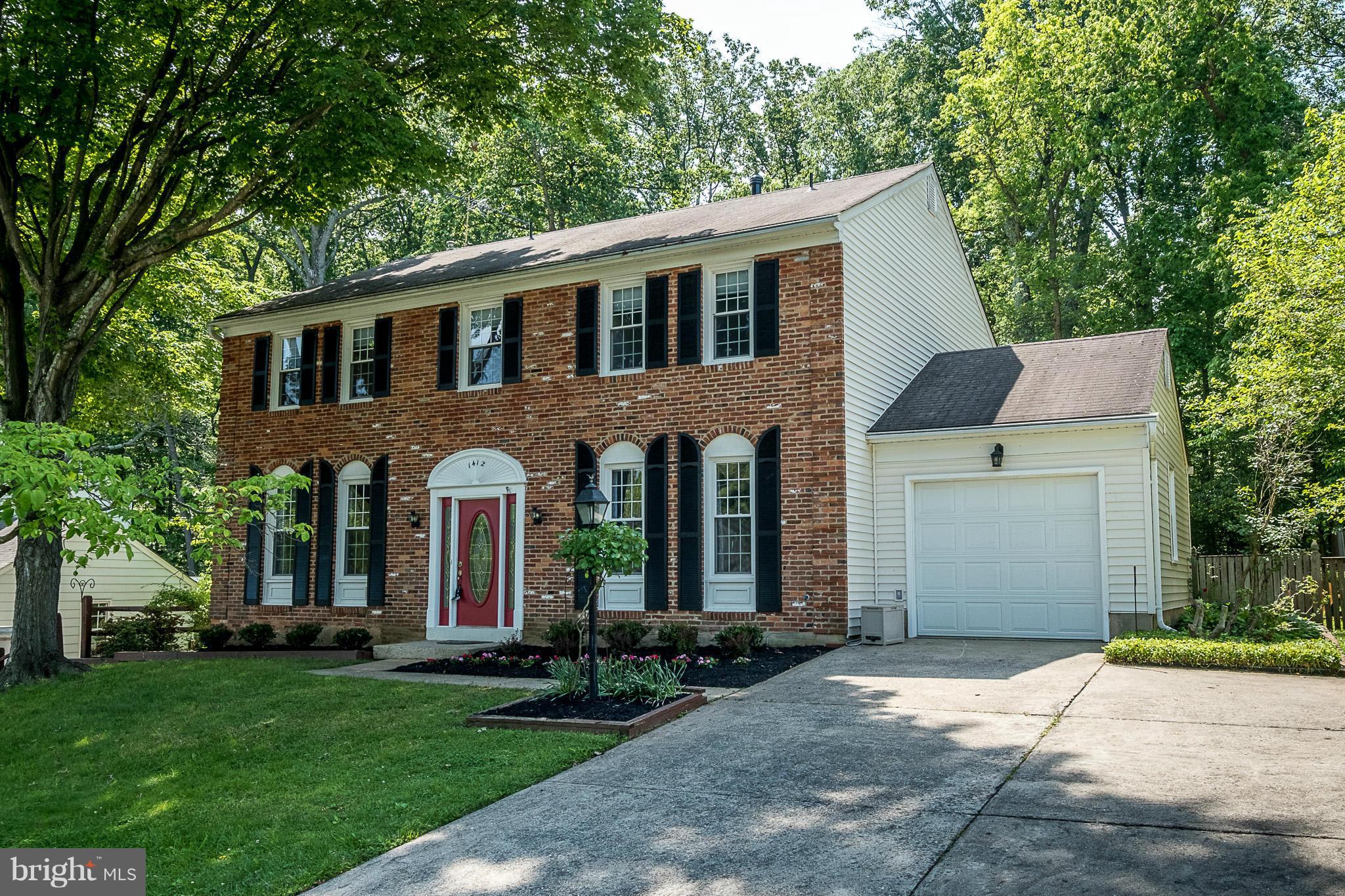 1412 Winding Waye Lane Silver Spring, MD 20902 - Photo 2 of 30 a front view of a house with a garden and trees