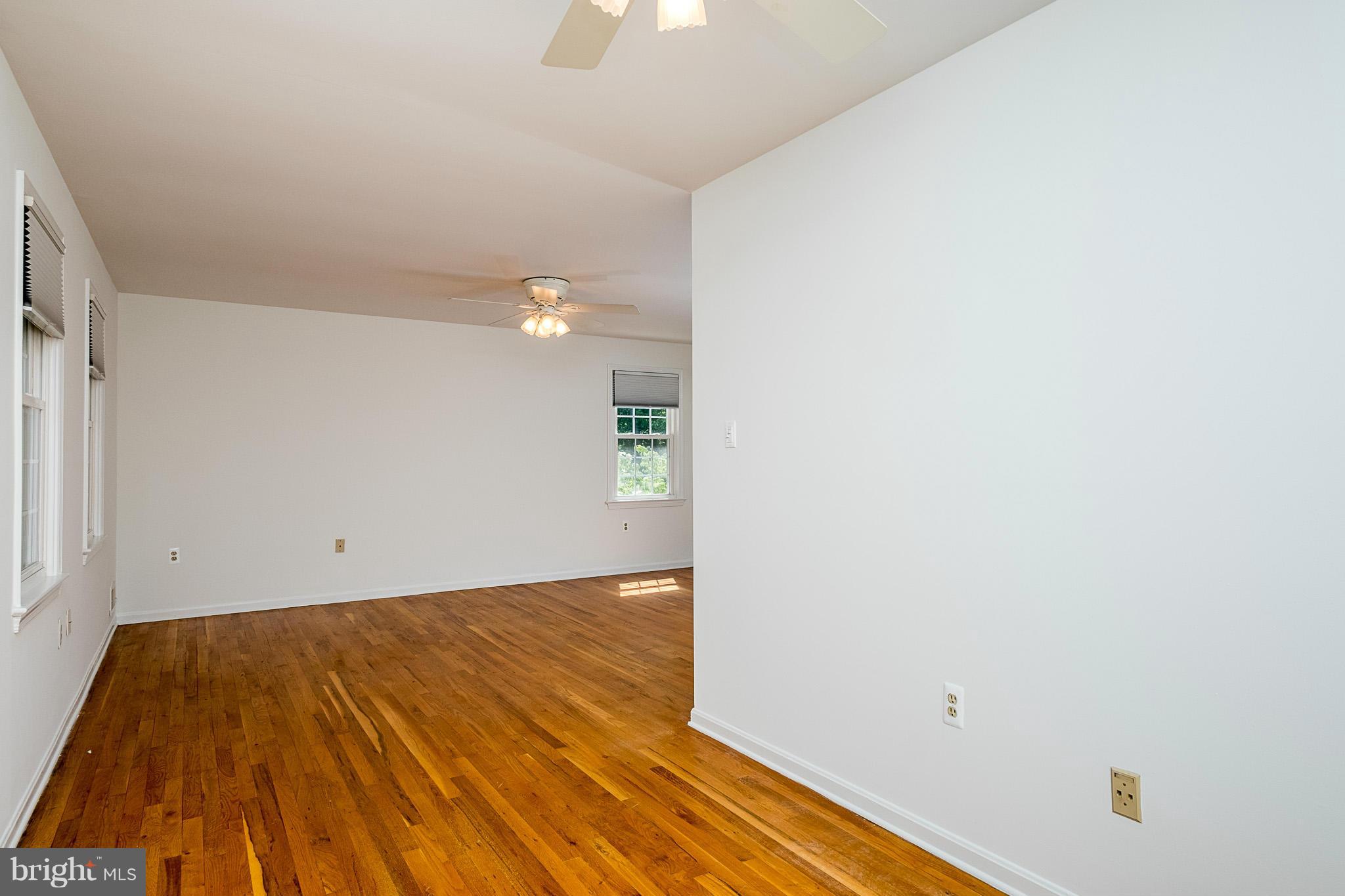 1412 Winding Waye Lane Silver Spring, MD 20902 - Photo 12 of 30 a view of a room with wooden floor and ceiling fan