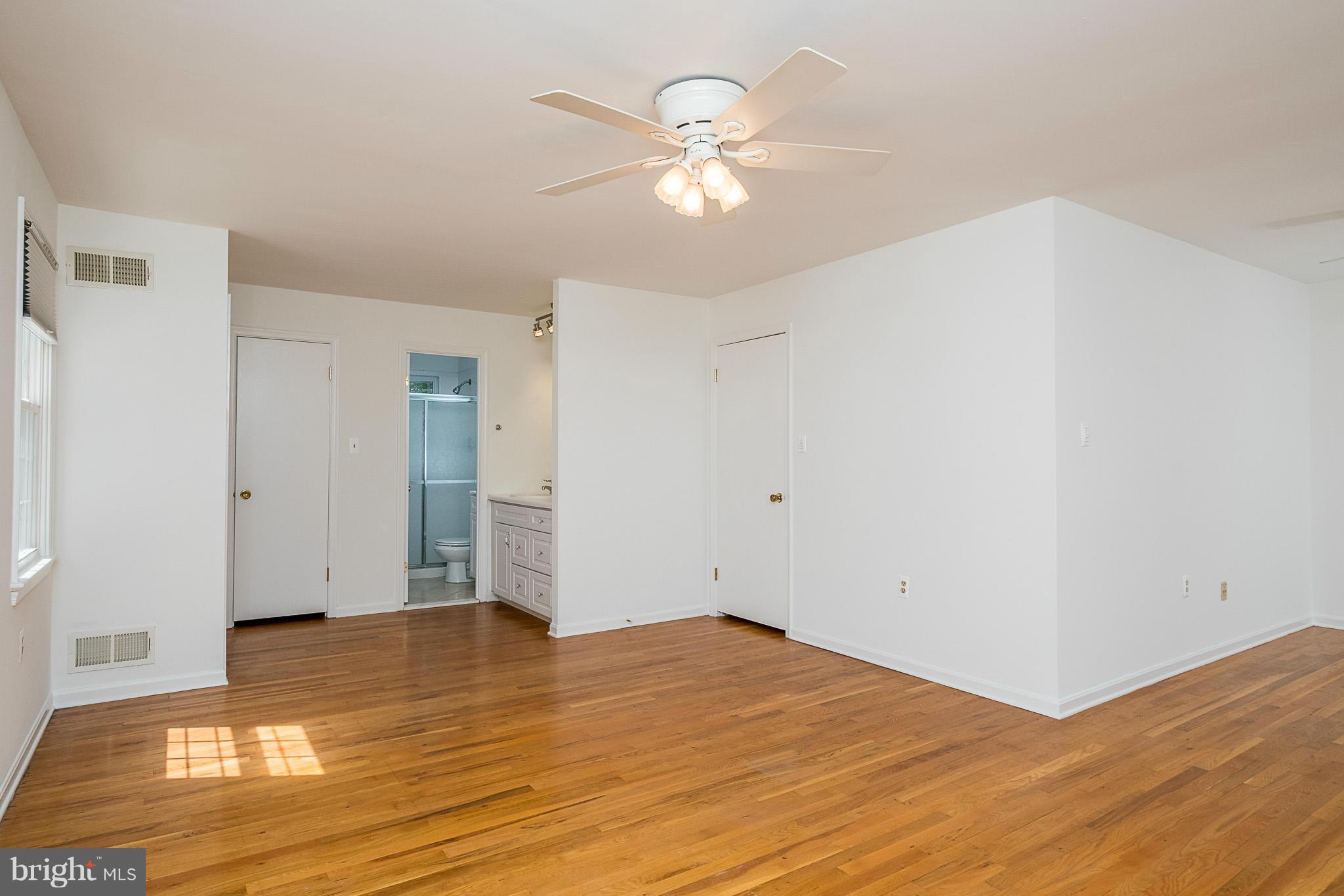 1412 Winding Waye Lane Silver Spring, MD 20902 - Photo 13 of 30 a view of empty room with wooden floor and ceiling fan