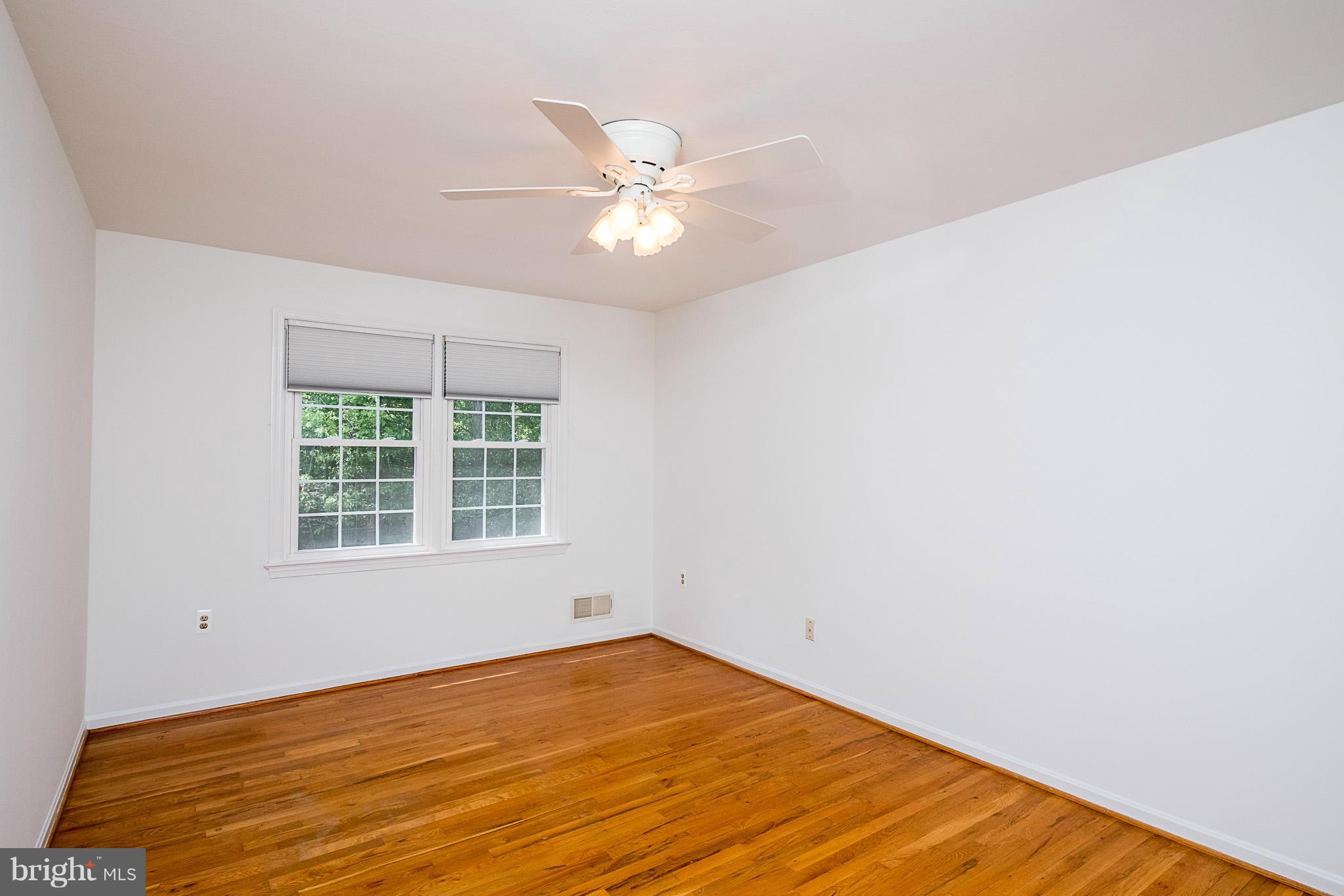1412 Winding Waye Lane Silver Spring, MD 20902 - Photo 18 of 30 a view of an empty room with window and chandelier fan